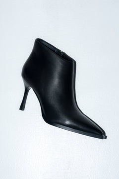 Low black women’s high-heeled ankle boots in genuine leather with a pointed toe.