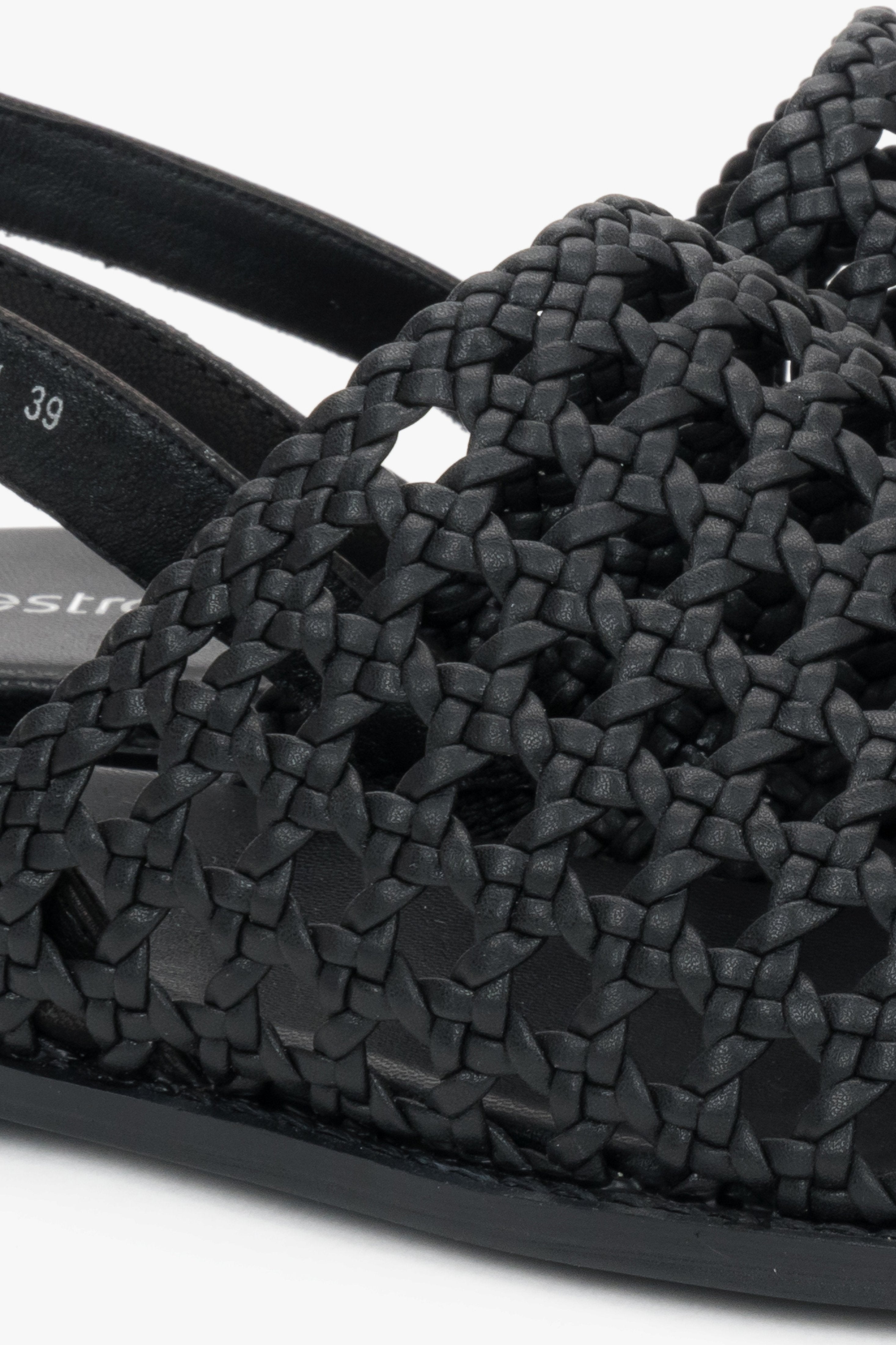 Genuine leather black sandals with an intricate woven upper.