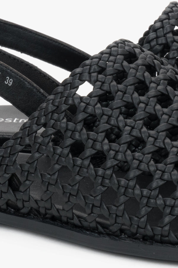 Genuine leather black sandals with an intricate woven upper.