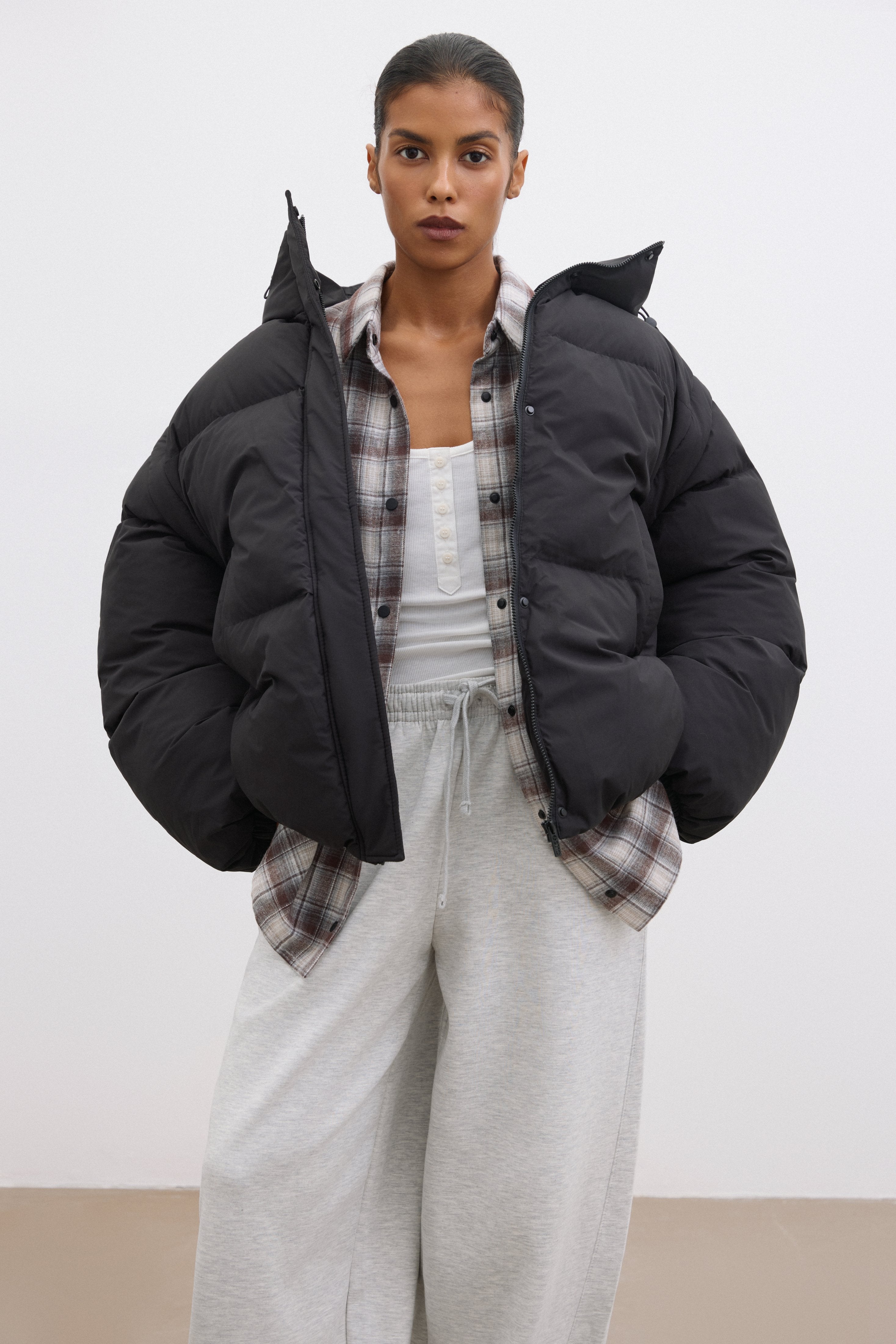 Black Women's Oversized Jacket with Detachable Sleeve Feature.
