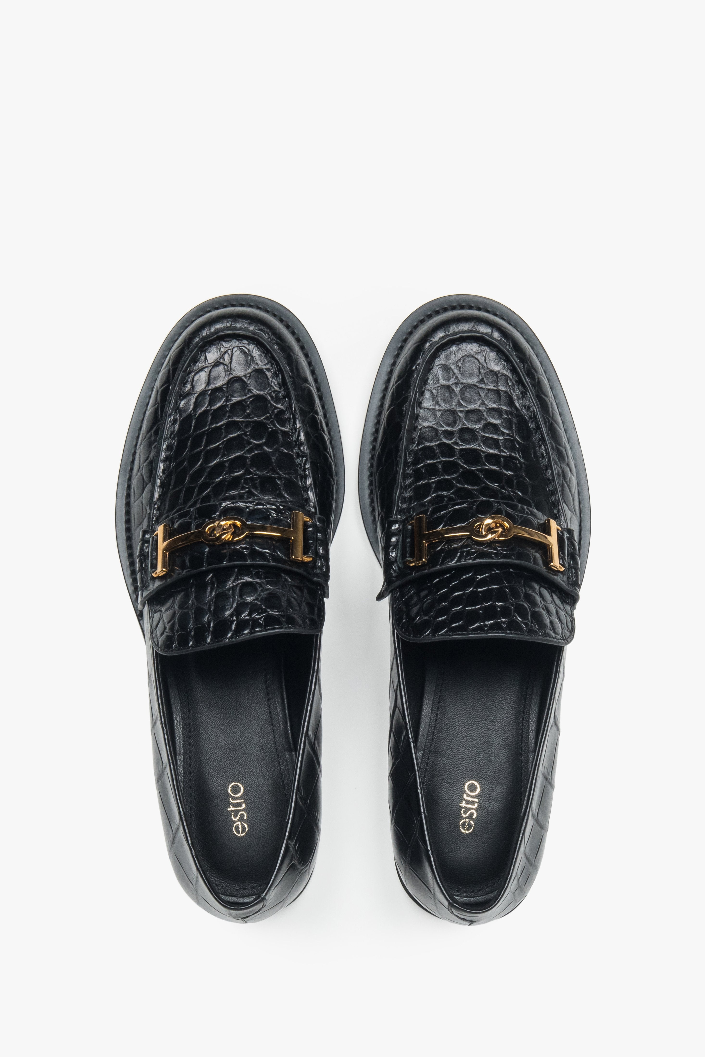 Women’s loafers Estro, black, made of patent natural leather, with a decorative buckle.