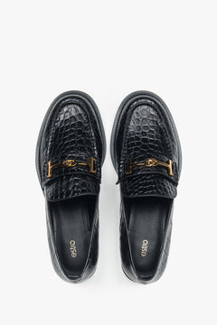 Women’s loafers Estro, black, made of patent natural leather, with a decorative buckle.