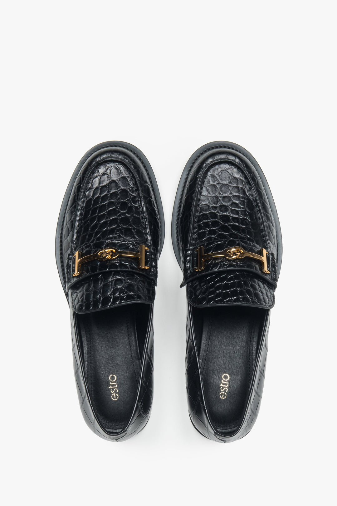 Women’s loafers Estro, black, made of patent natural leather, with a decorative buckle.