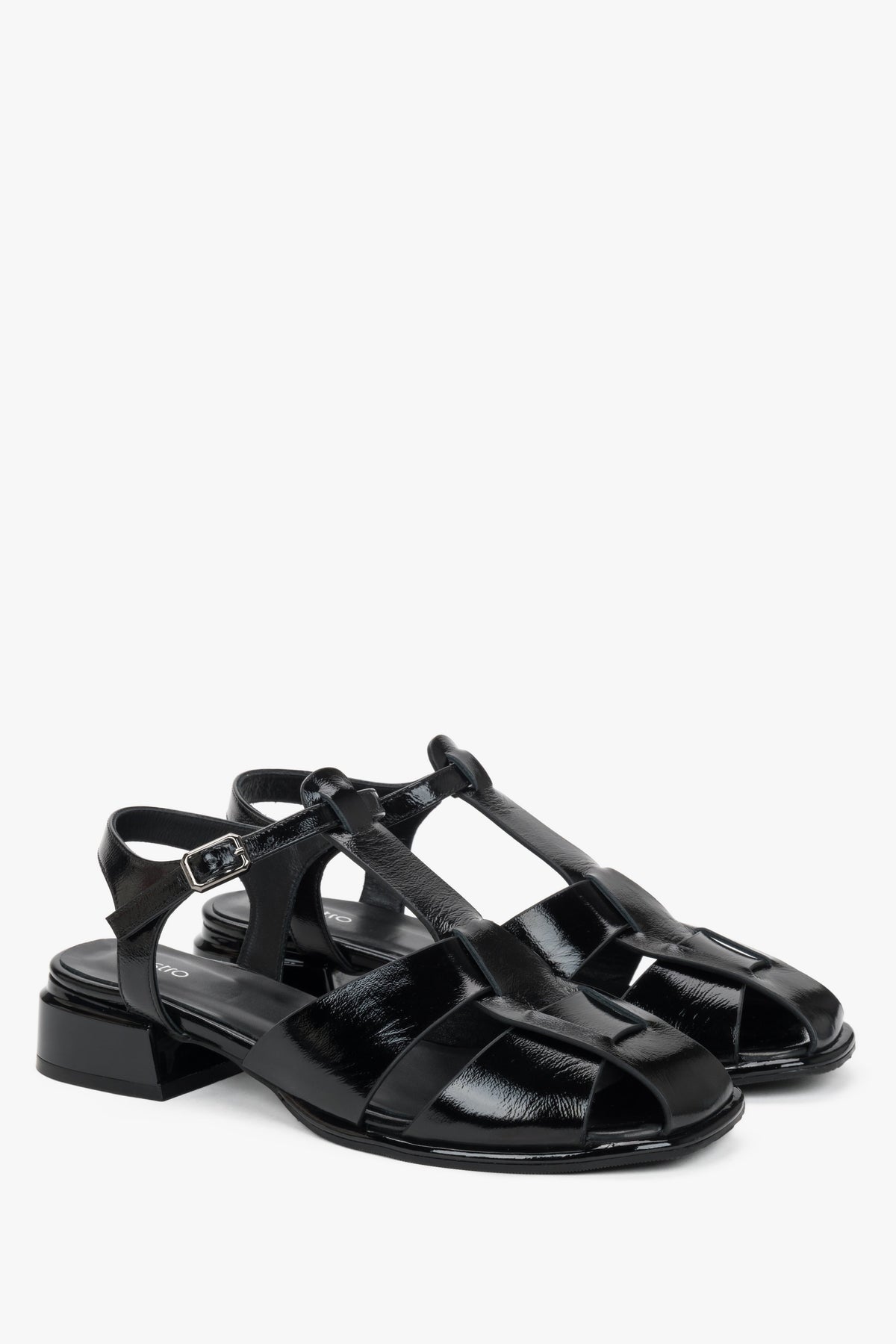 Women's black patent leather low block heel sandals.