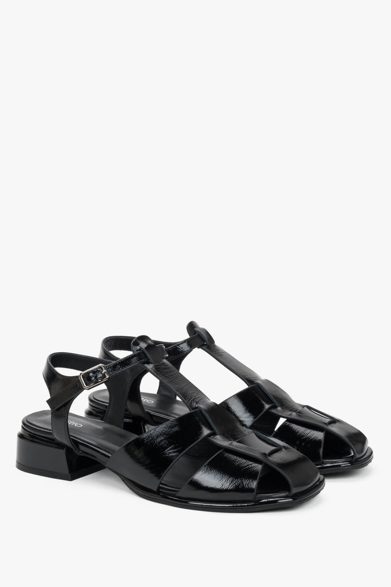 Women's black patent leather low block heel sandals.
