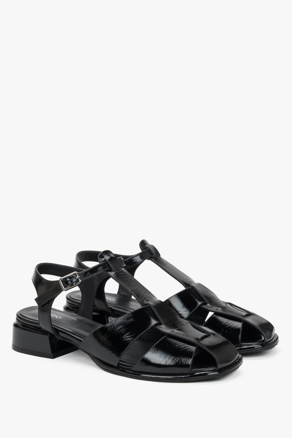 Women's black patent leather low block heel sandals.