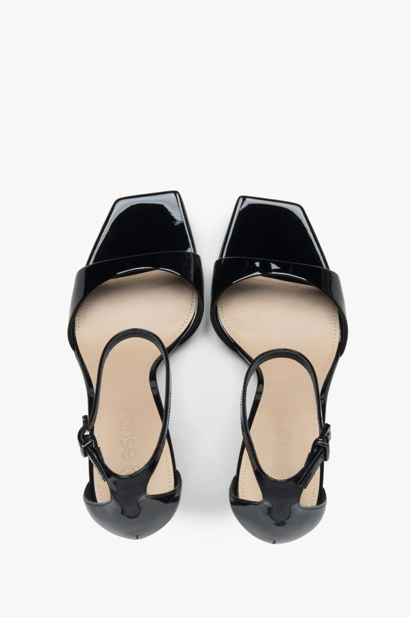 Made of patent natural leather, women’s black sandals on a stable block heel Estro.