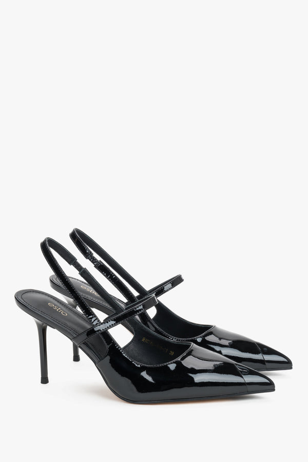 Elegant black patent leather heels featuring a pointed toe and stabilizing foot strap.
