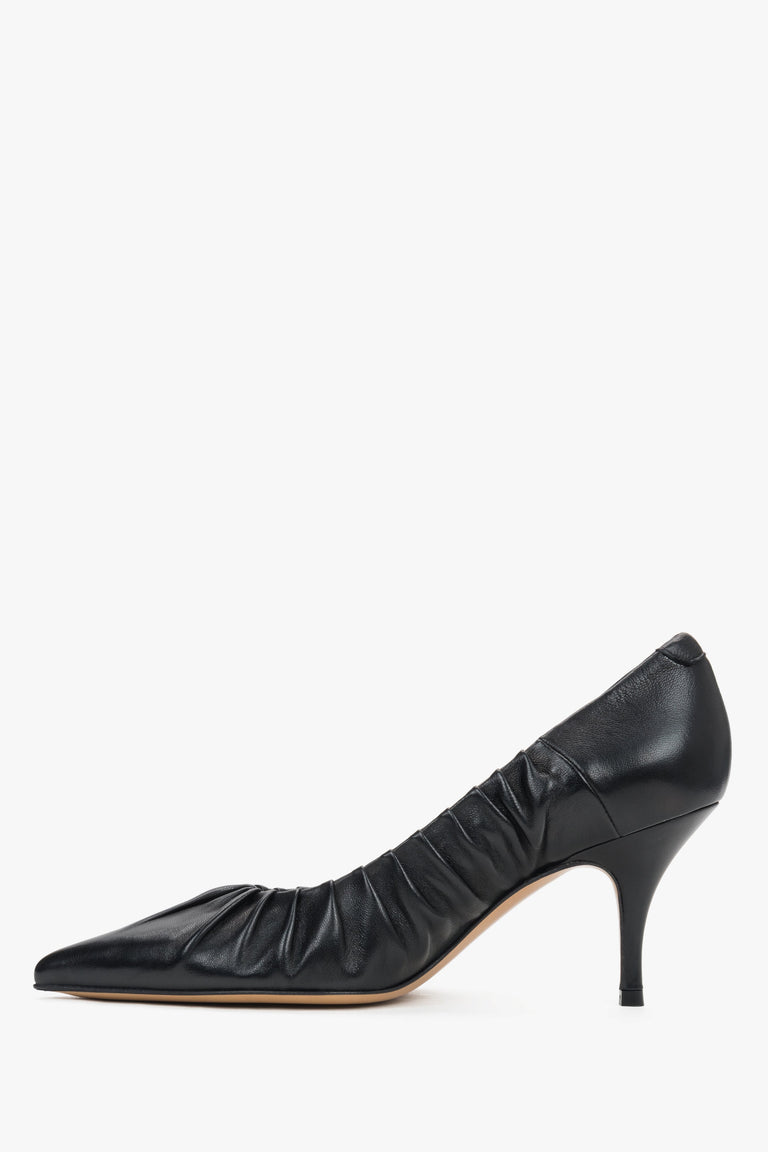 Close-up of the artisanal gathered leather edge and pointed-toe design on luxury pumps.