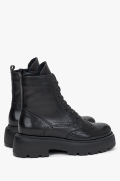 Women's black leather ankle boots Estro - side profile view highlighting the sleek silhouette, heel, and side zipper closure.