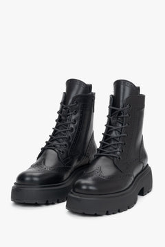 Women's black leather ankle boots Estro - front view showcasing the pointed toe and folk perforation pattern.