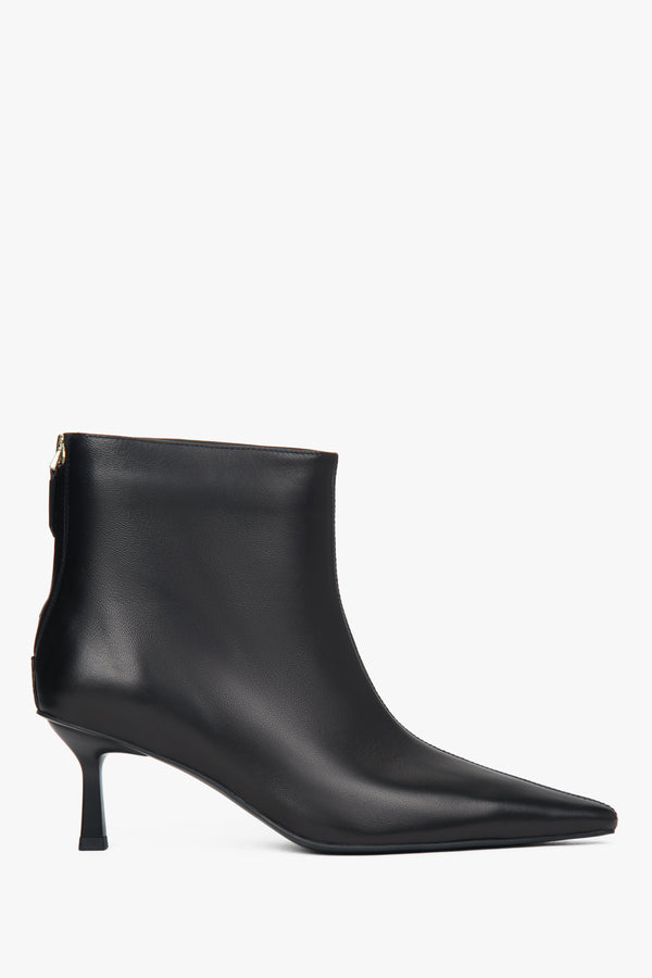Black, short women’s ankle boots made of genuine leather with a low heel.
