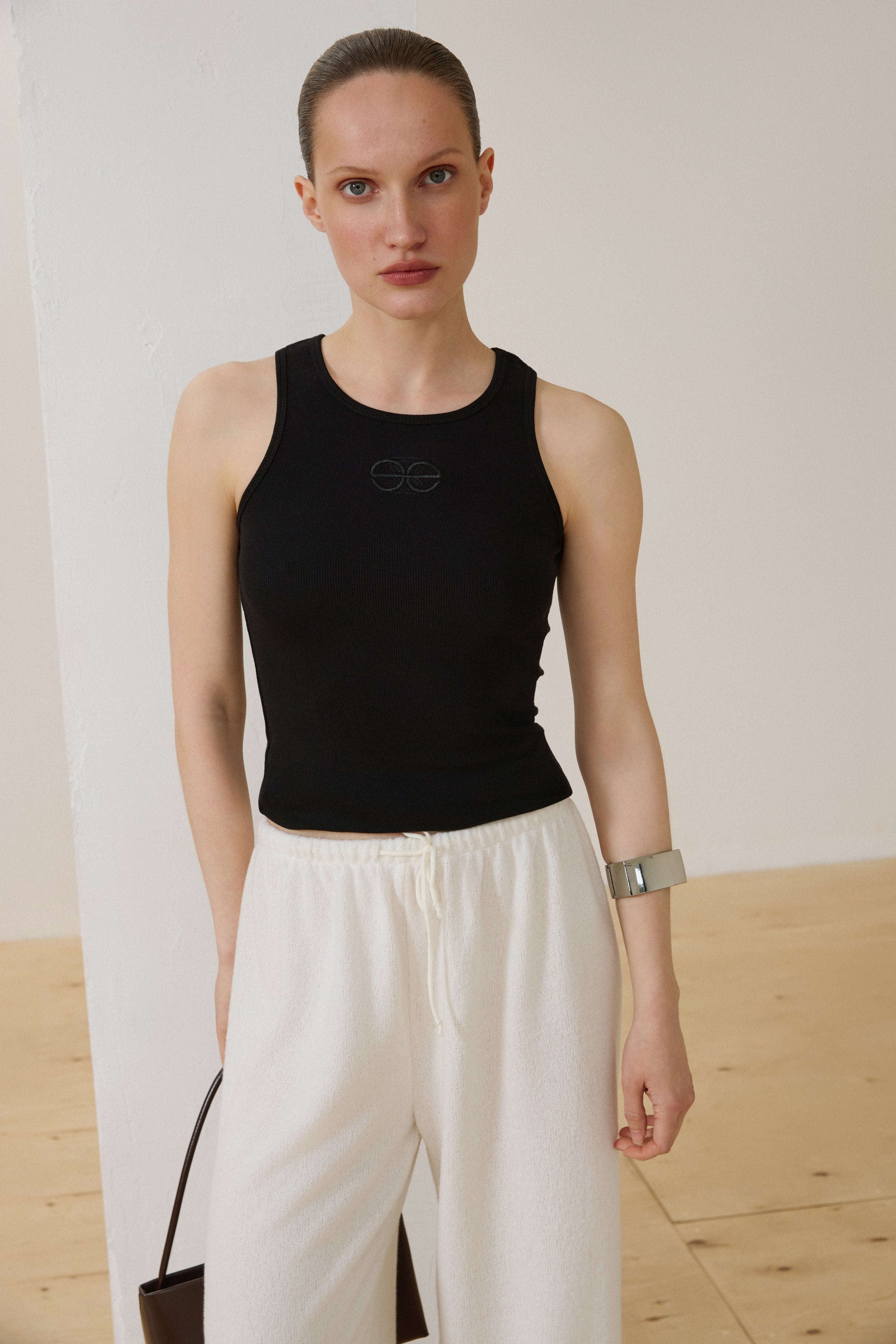 Black sleeveless ribbed cotton top by Estro.