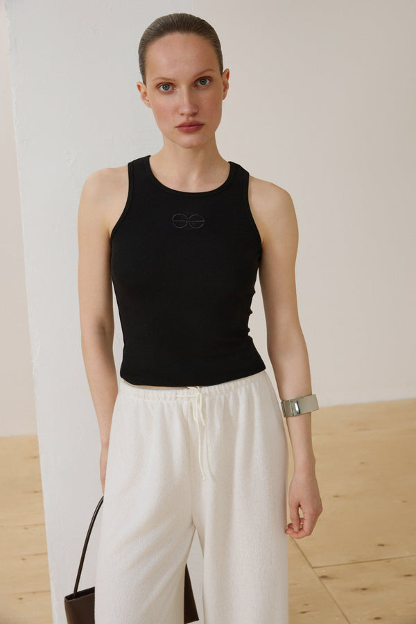 Black sleeveless ribbed cotton top by Estro.