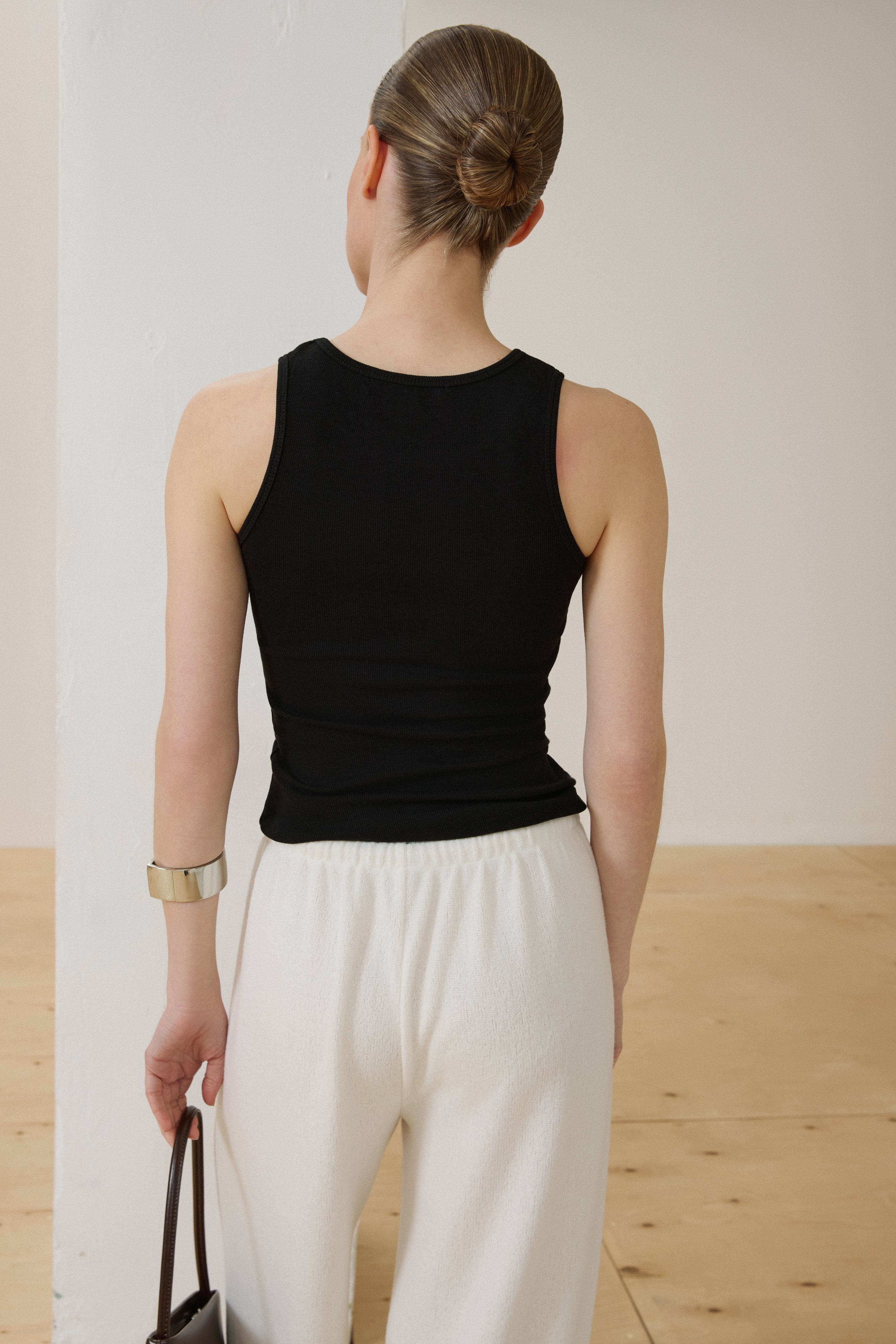 Back of women's black ribbed sleeveless top.