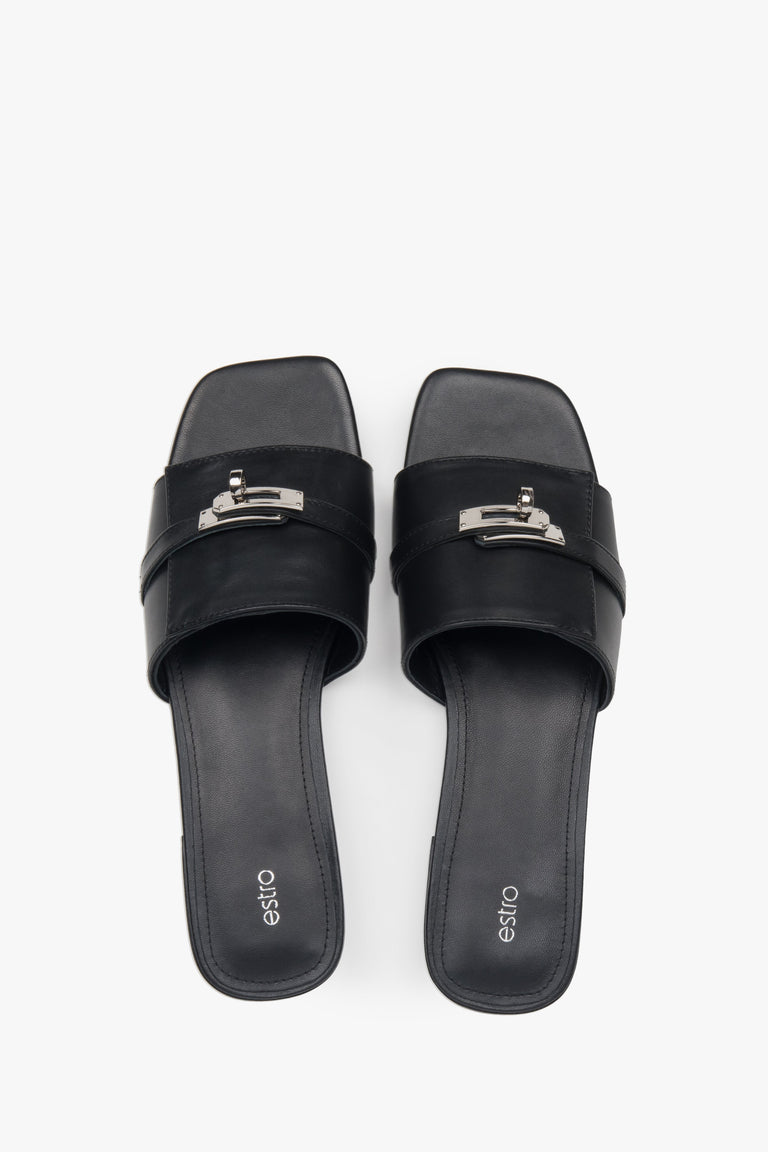 Classic black Estro women's slide sandals, refreshingly accented with a silver embellishment — perfect for summer and comfortable thanks to the flat sole.