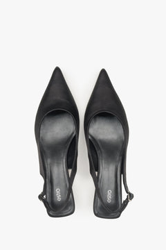 Timeless black slingback women’s pumps by Estro, crafted from soft textiles and set on a low heel.