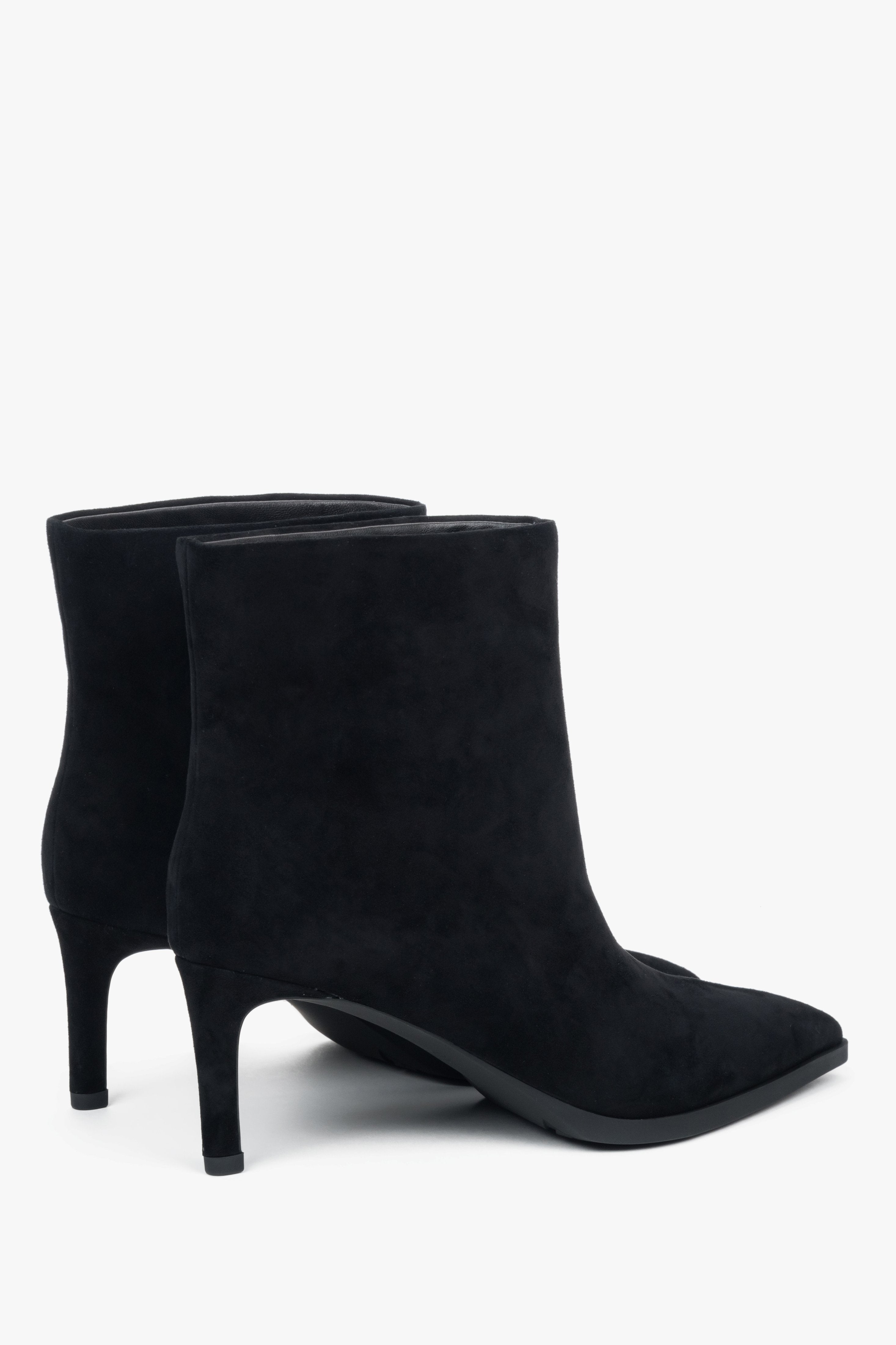 With a stiletto heel, short, black women’s ankle boots made of genuine velour Estro.