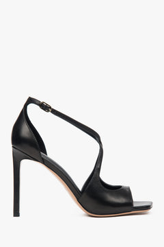 Women’s black stiletto sandals with decorative fastening.