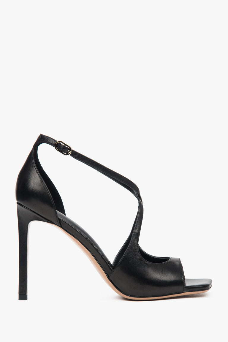 Women’s black stiletto sandals with decorative fastening.