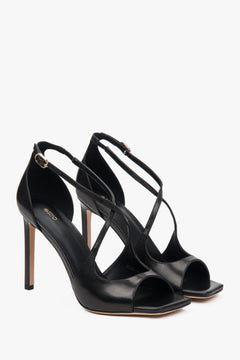 Women’s black stiletto sandals with decorative fastening by Estro.