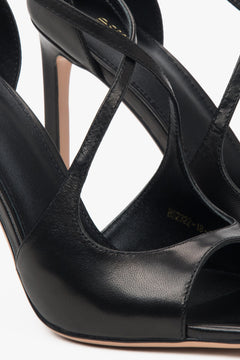 Women’s black stiletto sandals with decorative fastening by Estro.