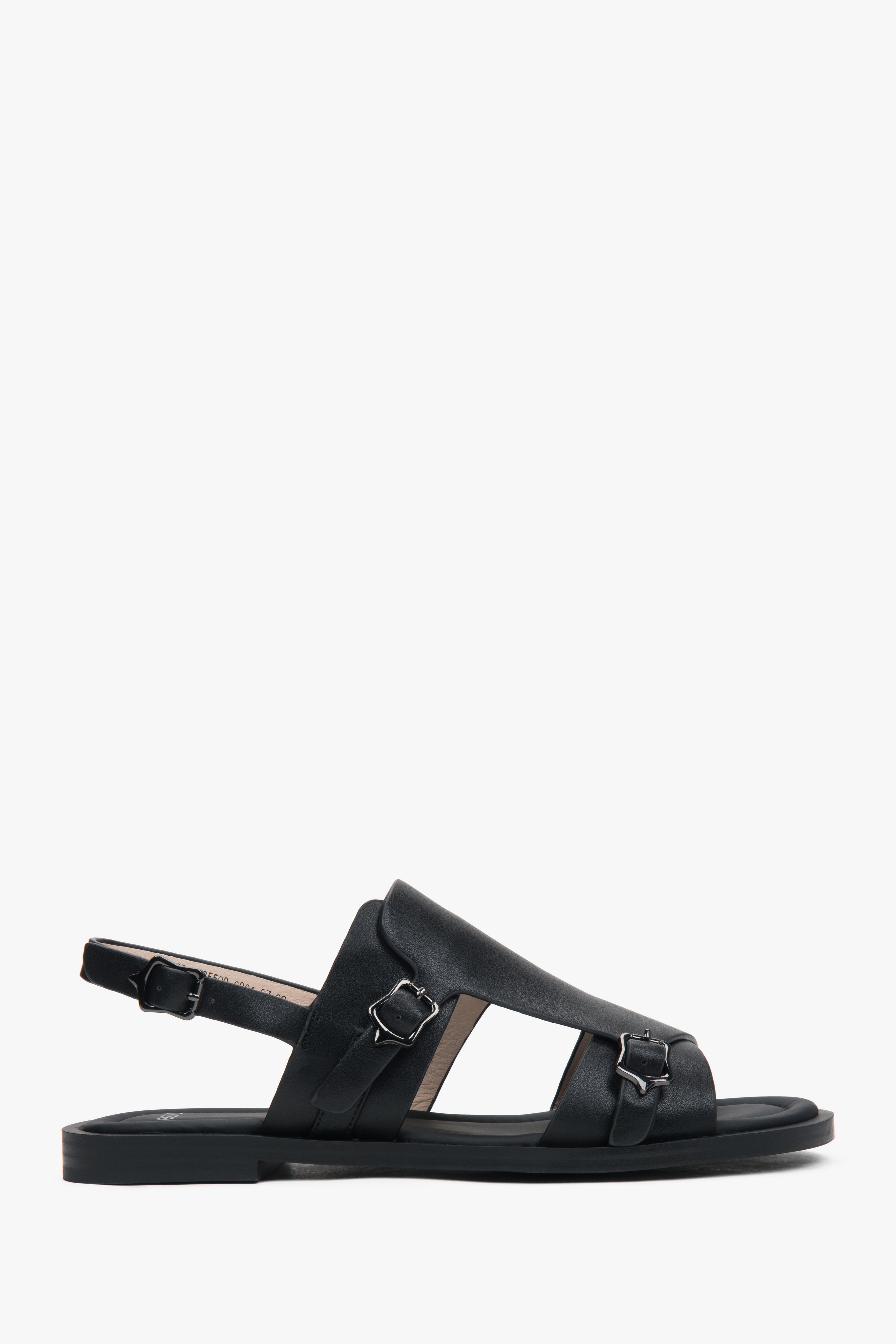 Black closed-toe women’s sandals on a flat natural leather sole.