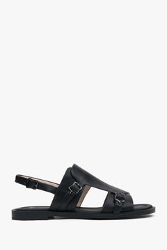 Black closed-toe women’s sandals on a flat natural leather sole.