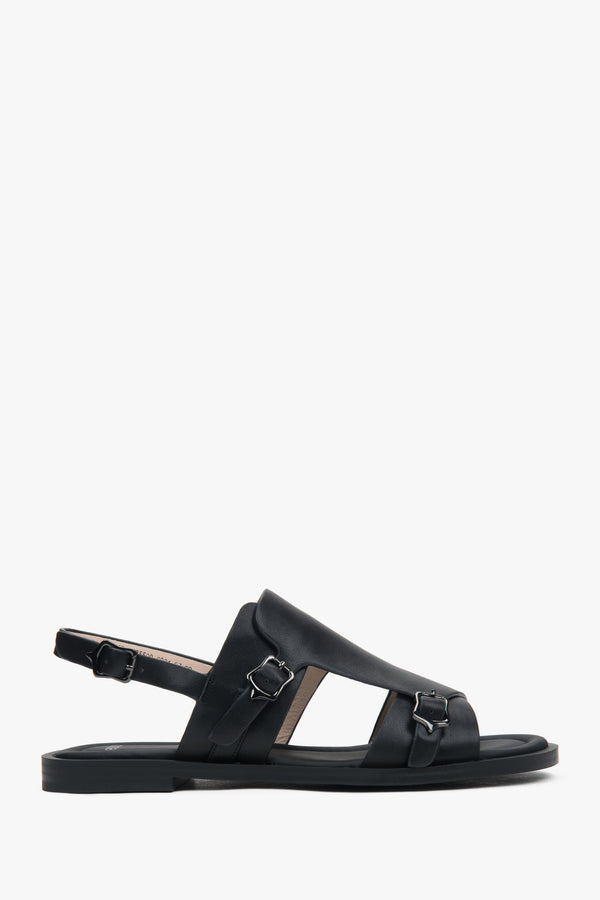 Black closed-toe women’s sandals on a flat natural leather sole.