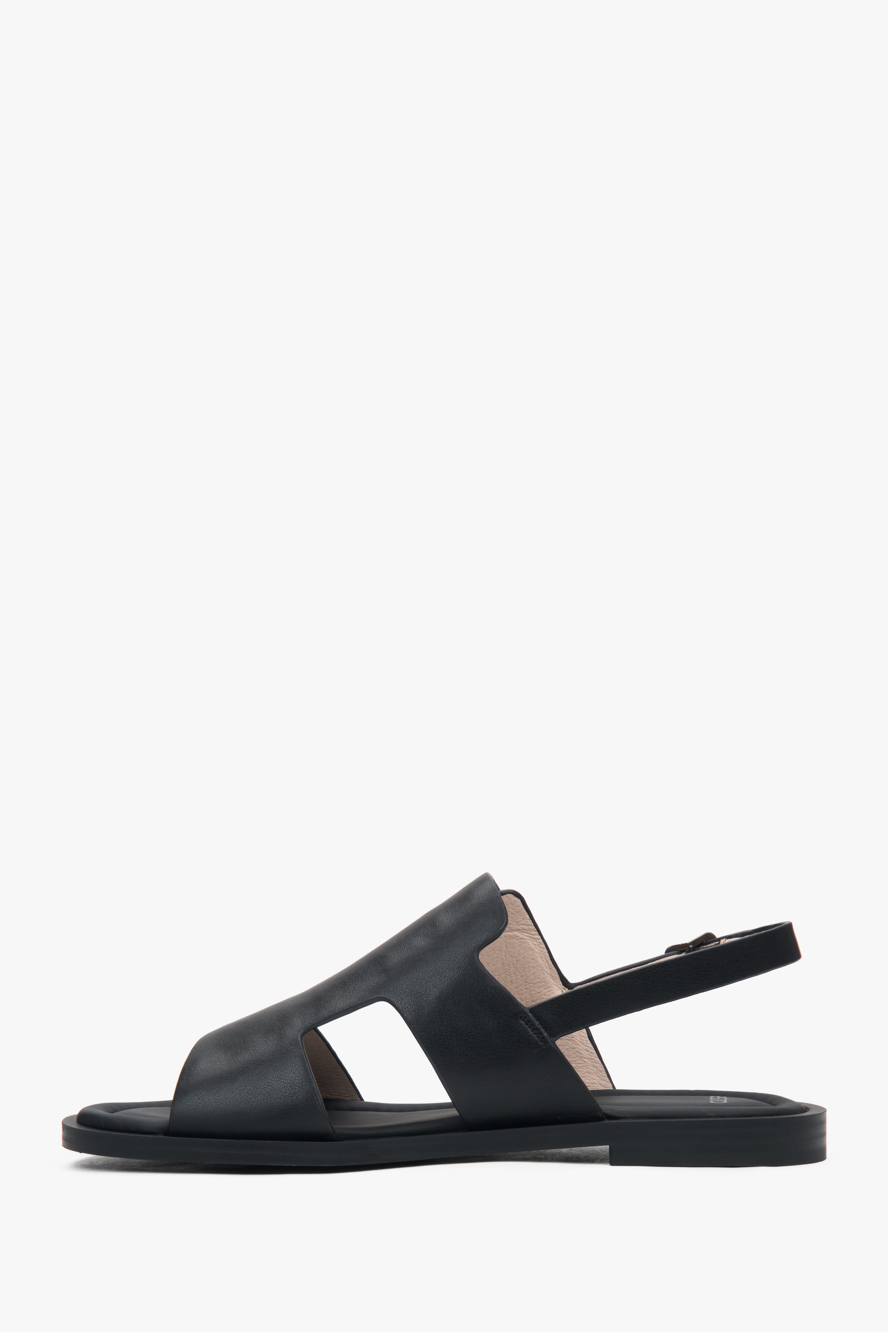 Women’s black closed-toe sandals on a flat natural leather sole by Estro.