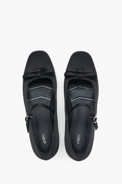 Estro black textile ballet flats featuring a buckle.