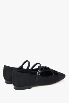 Soft black textile ballet flats with decorative buckle.