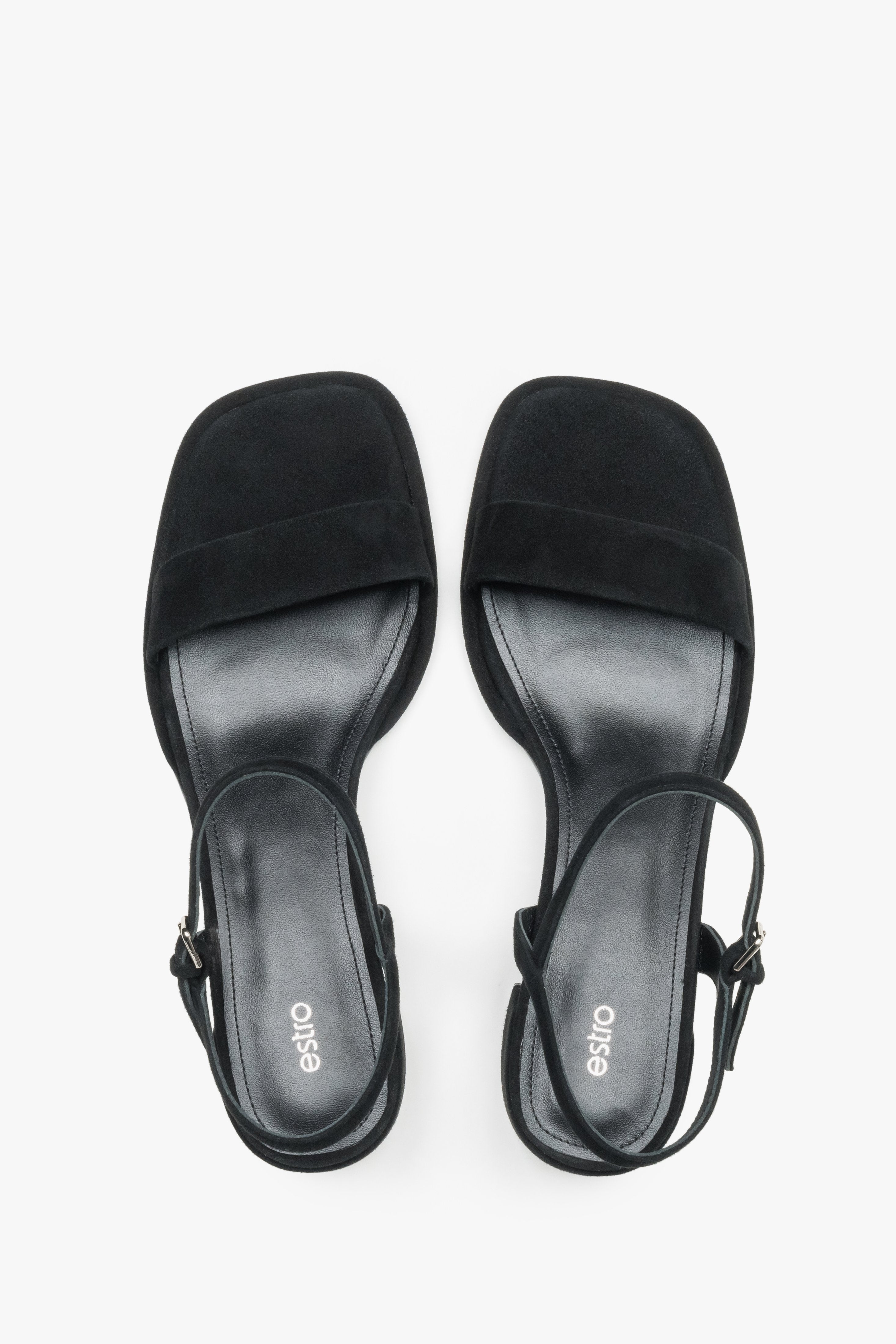 Estro black sandals featuring a low square heel and adjustable ankle strap.