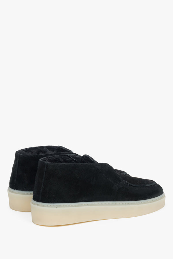 Black fur-lined women’s velour loafers.