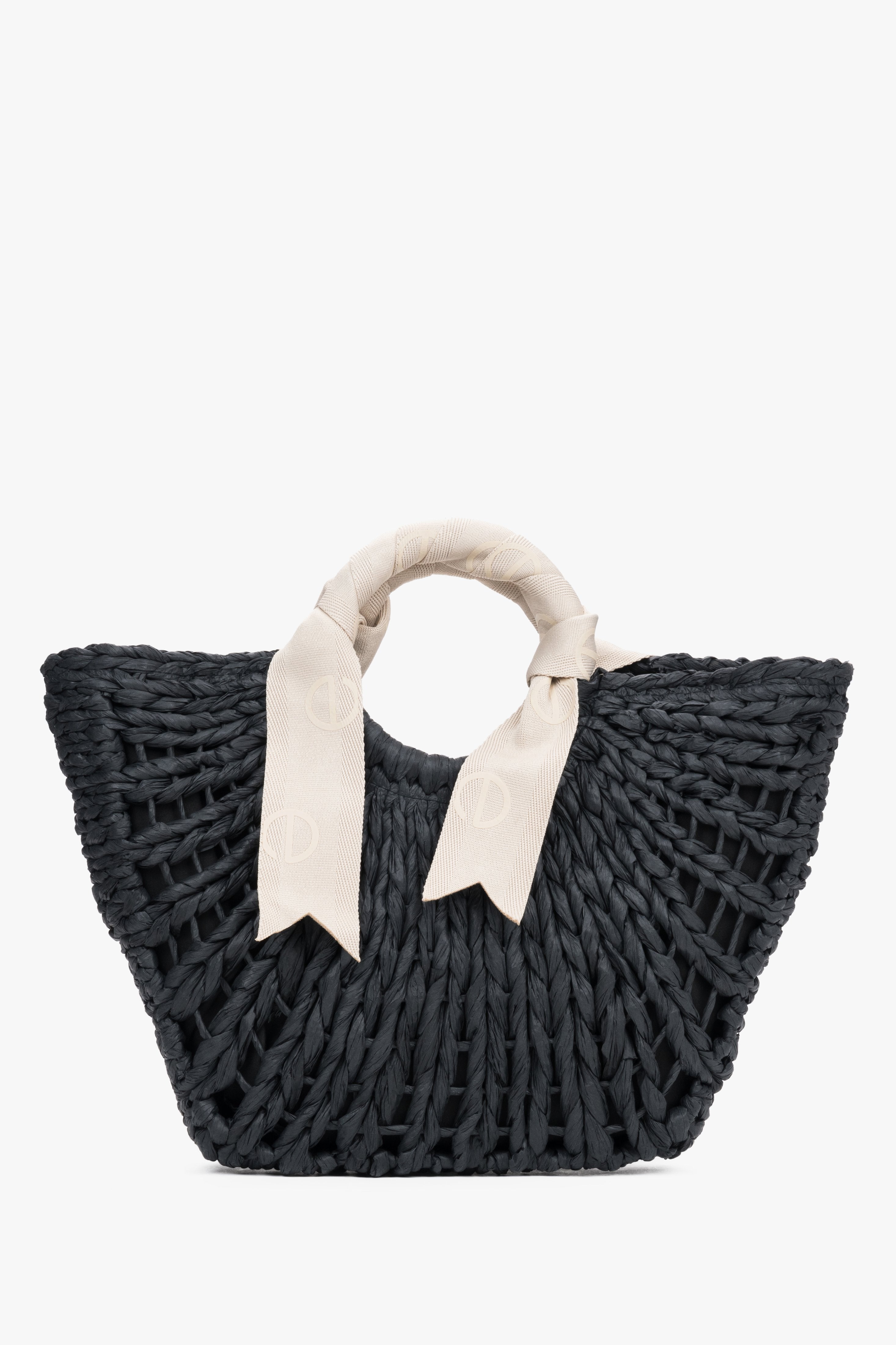 Black woven basket bag with white handle.