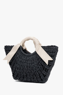 Back woven texture bag with white handle.
