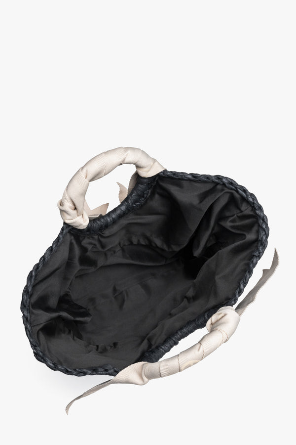 Inside view of black woven women's handbag.