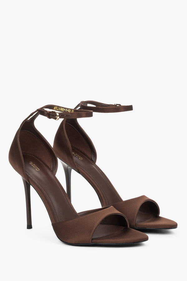 Angled view of women's brown high heel sandals with feather trim