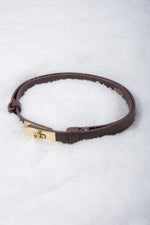 Elegant brown leather belt from Estro, measuring 95 cm in length, shown styled around the waist to complement a chic outfit.