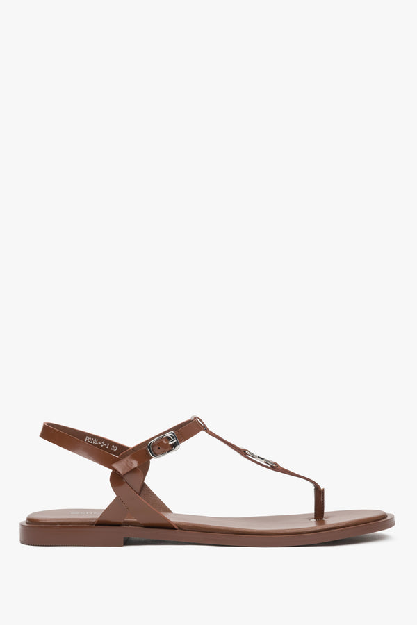 Brown women’s leather flip-flop sandals with a flat sole.