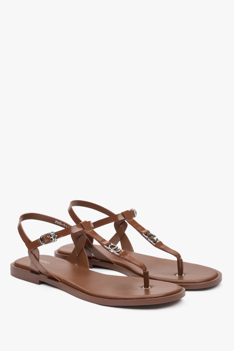 Women’s brown leather flip-flop sandals with a flat sole.