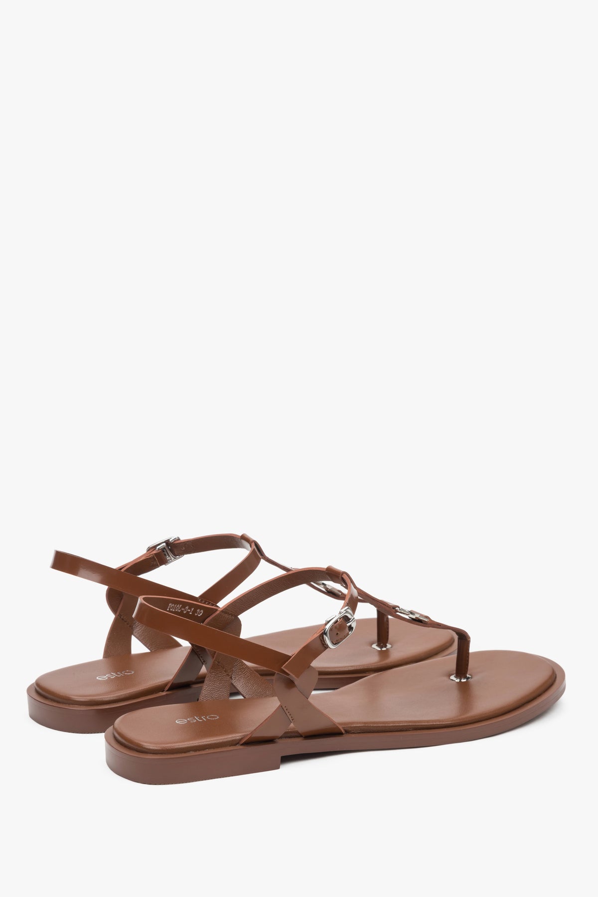 With a flat sole, brown women’s leather flip-flop sandals.