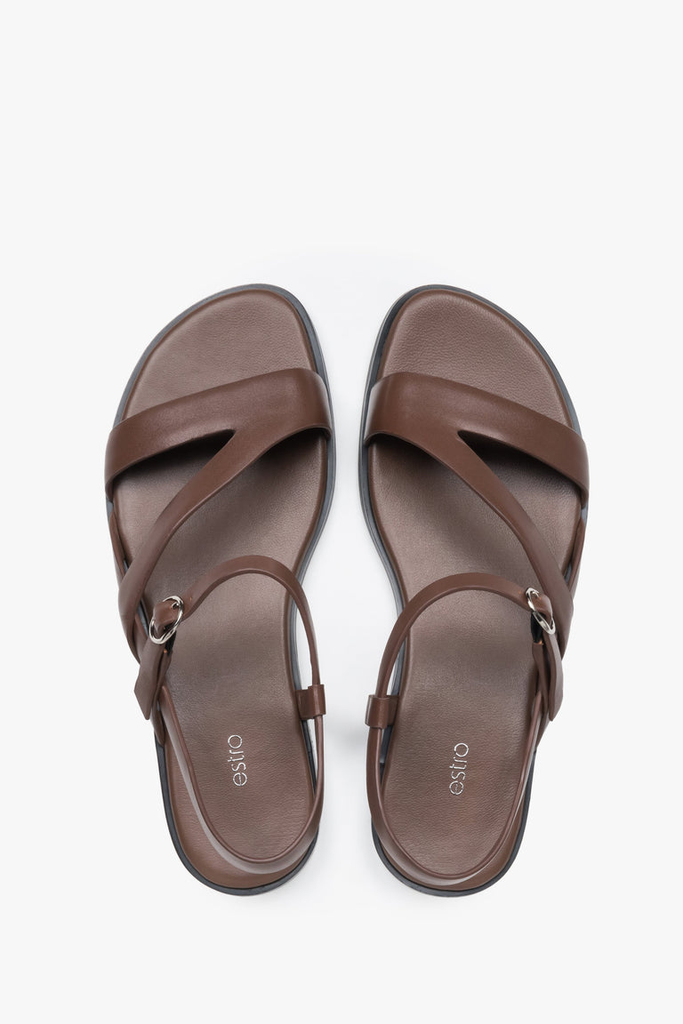 Women’s brown leather Estro sandals with crisscross straps and a flat sole.