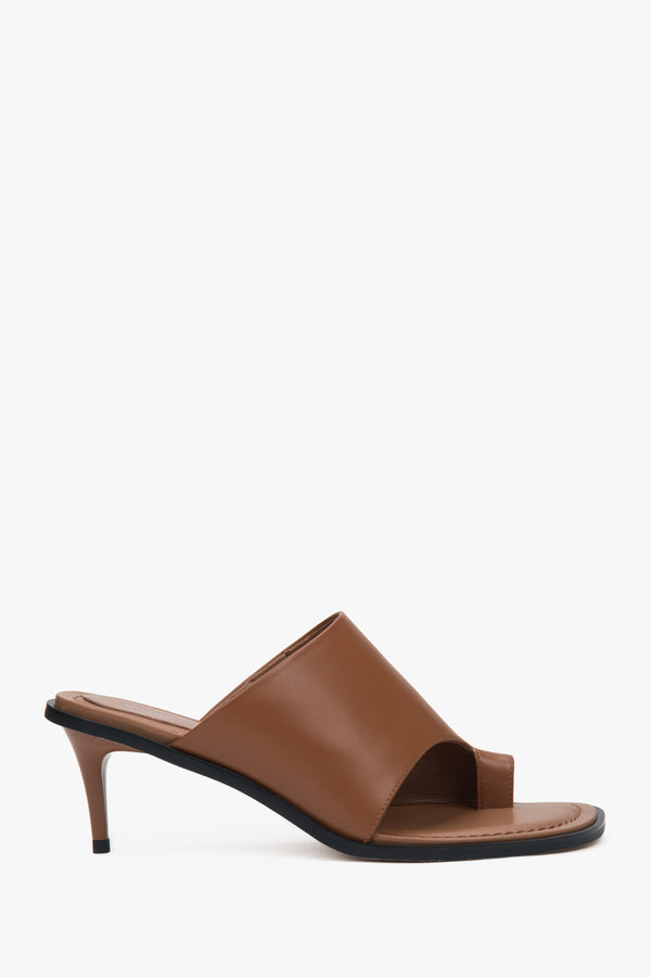 Brown women’s leather stiletto mules with a toe ring.