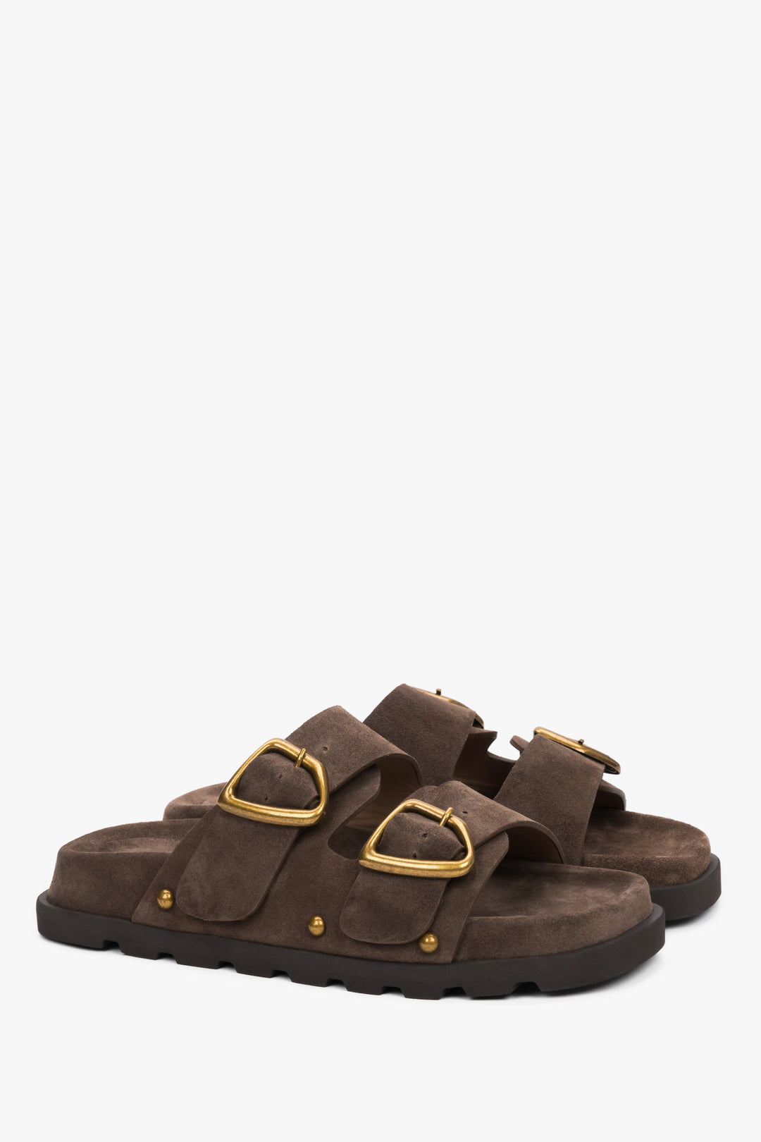 Women’s brown velour slides with a silver buckle and studs.