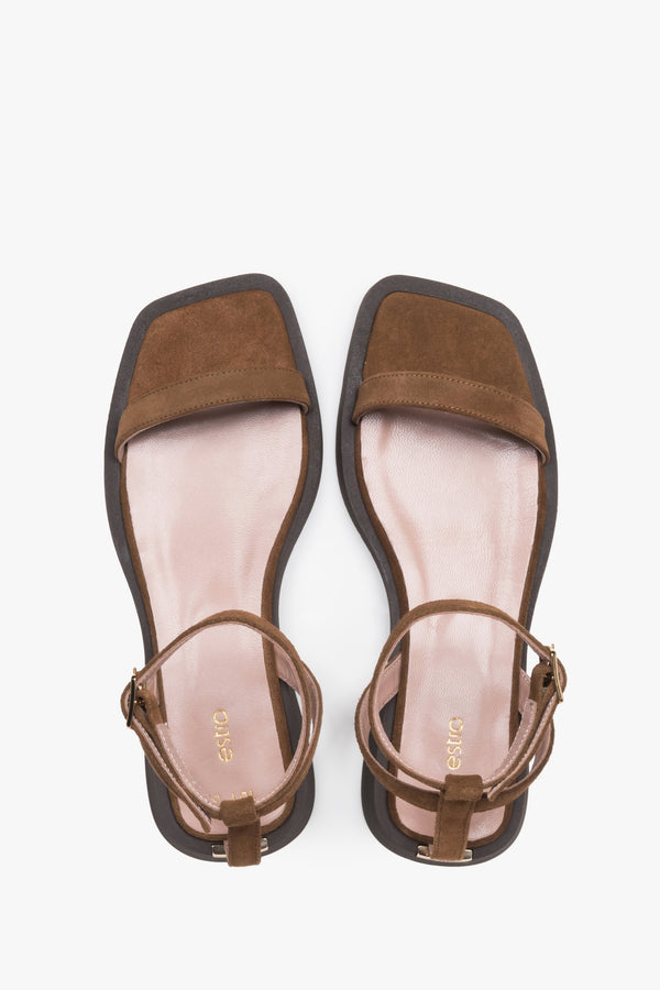 Top view of women’s brown flat sandals with slim velour straps.