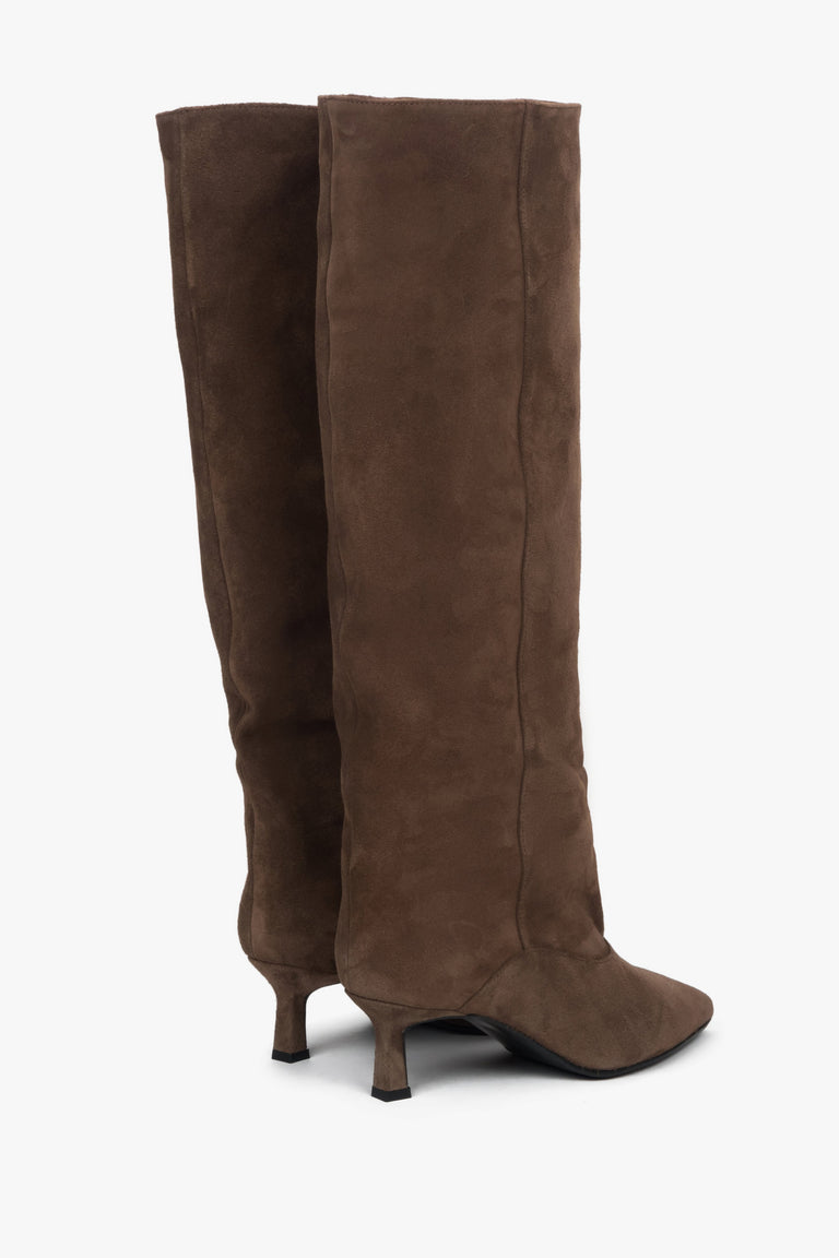 With a low flared heel, women's brown knee-high boots made of genuine velour.