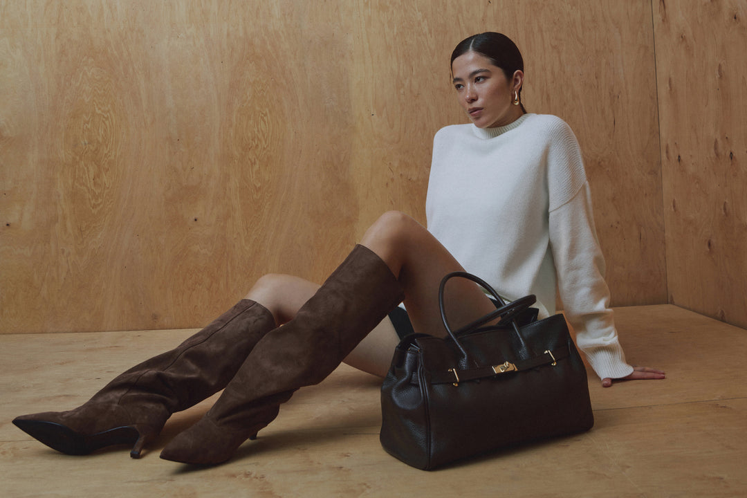 Women's brown knee-high boots made of genuine velour with a low flared heel.