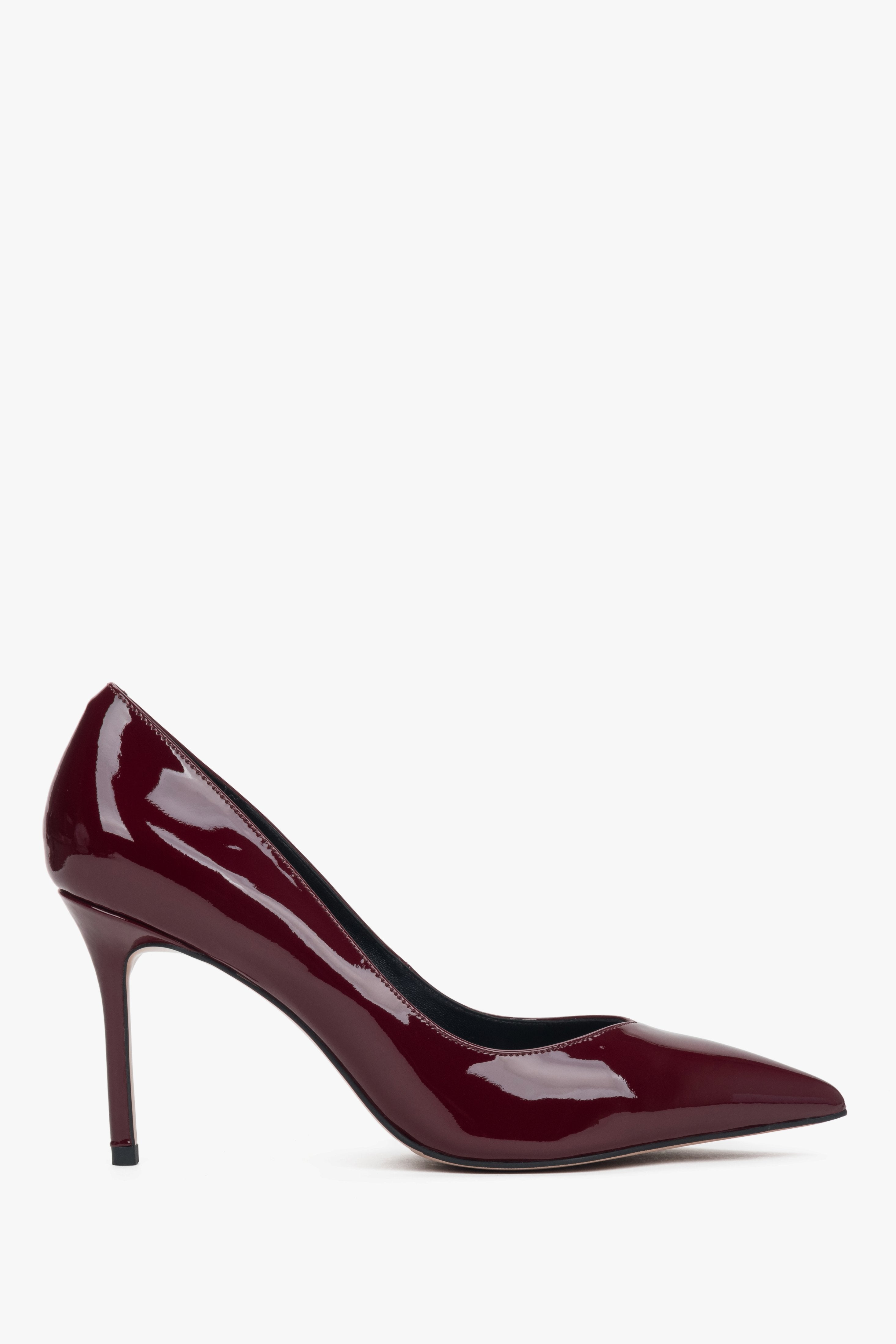 Dark red women’s high heel shoes made of patent leather.