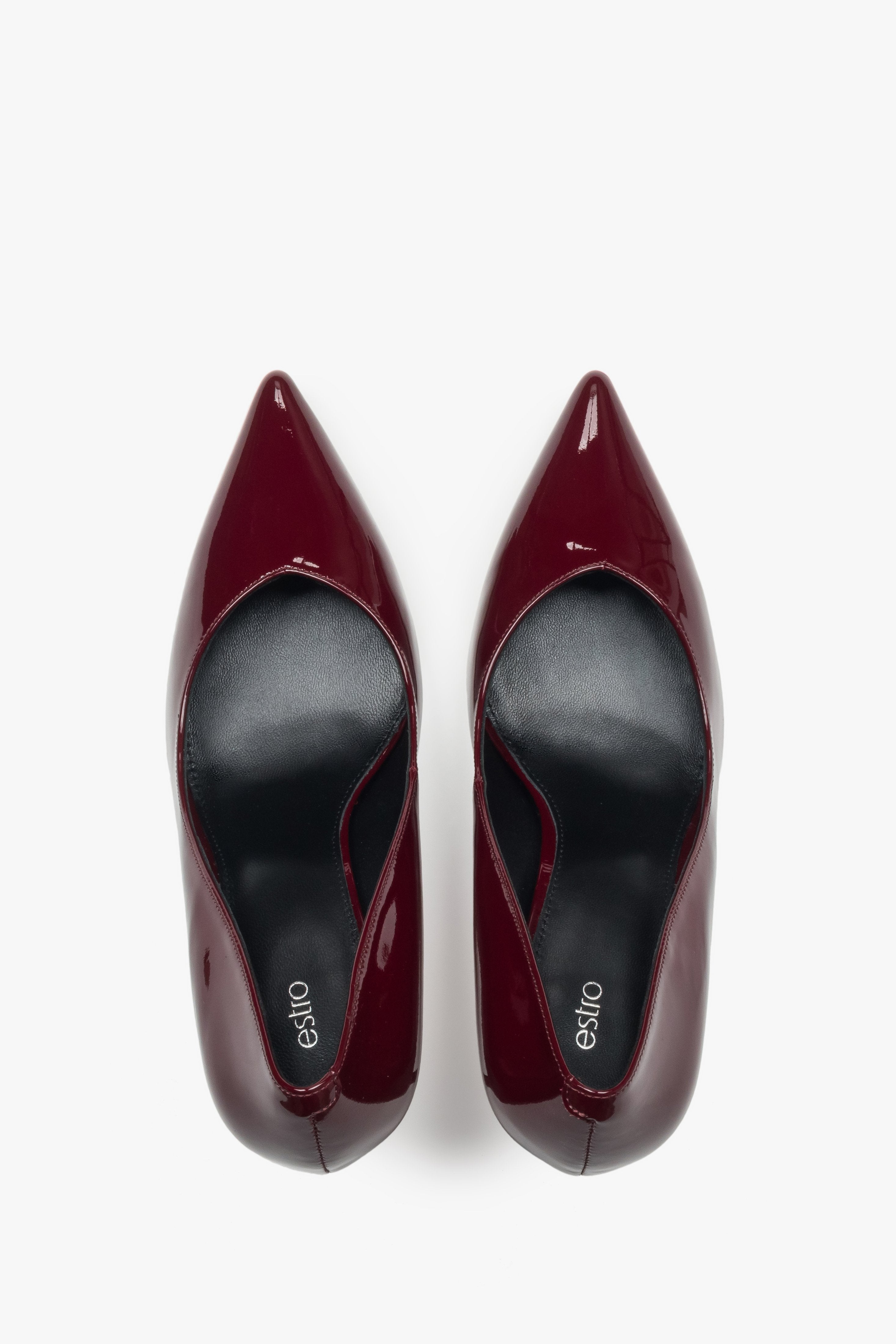 On a high heel, dark red women’s shoes made of patent leather Estro.